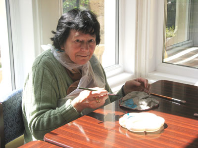 Working hard on her hand-painted clay bowl at my art workshop!